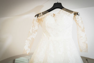 Wedding dress hanging from coathanger bridal shop