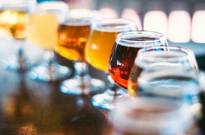 Various beers in wineglass on table