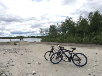 Bicycle on sand against sky