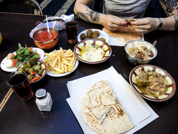 Midsection of woman having meal at table