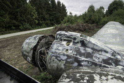 Close-up of abandoned car on field