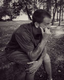 Young man sitting on field