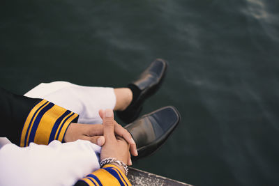 Close-up of man with hand in water