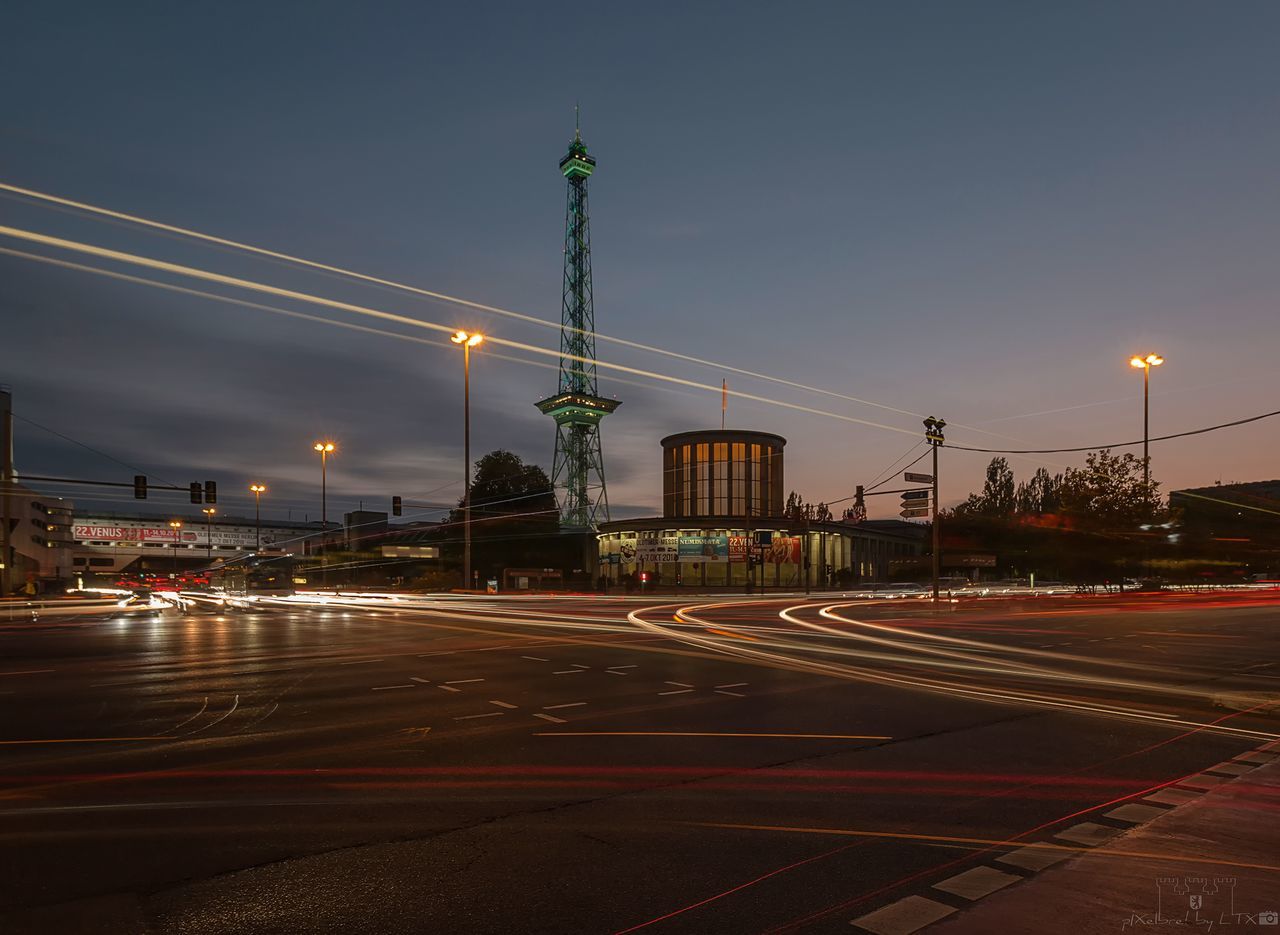 illuminated, street, transportation, city, built structure, architecture, road, sky, street light, building exterior, night, no people, lighting equipment, light trail, road marking, nature, symbol, sign, marking, mode of transportation, city street, outdoors, light