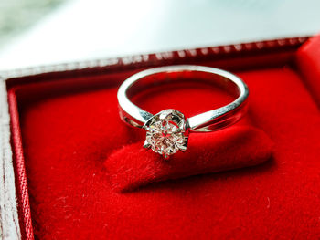 Close-up of wedding rings on red metal