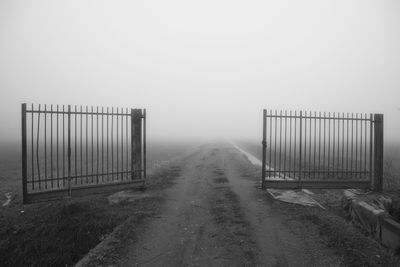 Fence on field against sky