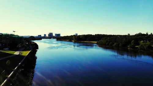 Reflection of trees in calm blue sea
