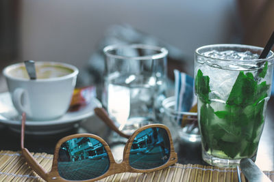 Close-up of drink and sunglasses on table