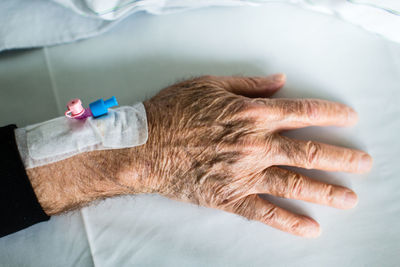 Cropped image of senior man hand in hospital