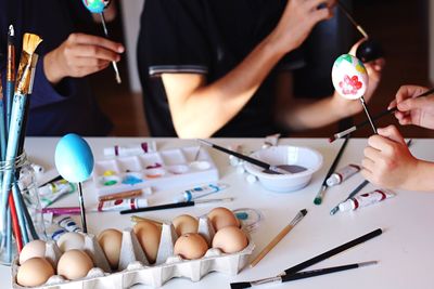 Close-up of people decorating easter eggs