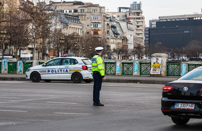 Man standing on street in city