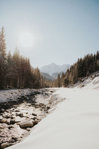 Scenic view of snow covered land against sky