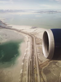Cropped image of airplane engine over landscape