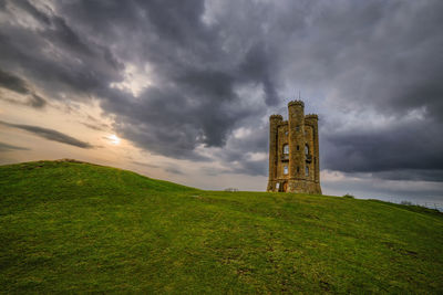 Tower on field against sky