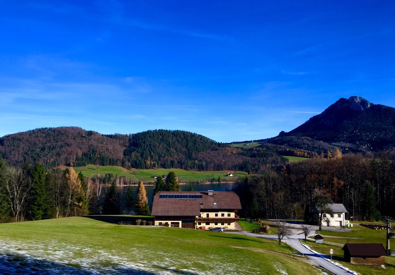 mountain, outdoors, mountain range, sky, no people, blue, day, beauty in nature, scenics, nature, grass, tree, architecture, water, golf course