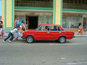 People on car on road in city