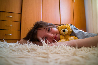Portrait of young woman with teddy bear