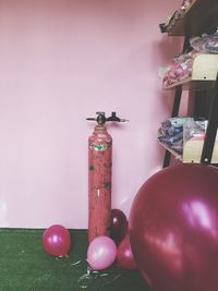 Balloons and air pump against wall