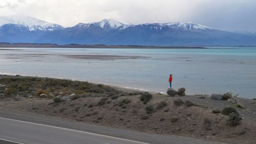 Scenic view of lake by mountains against sky