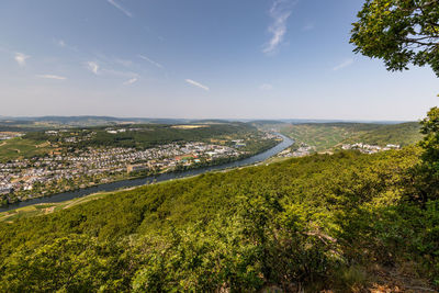 High angle view of city by sea against sky