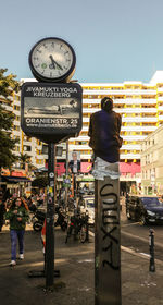 Rear view of woman standing on street in city