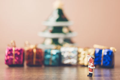 Santa claus and christmas gifts on table