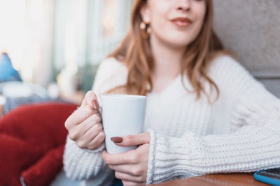 Young woman drinking coffee cup