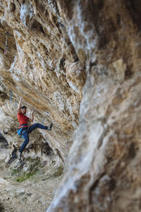 Climber begining a hard route in a sport climbing cave.