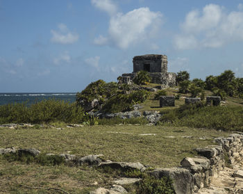 Built structure by sea against sky