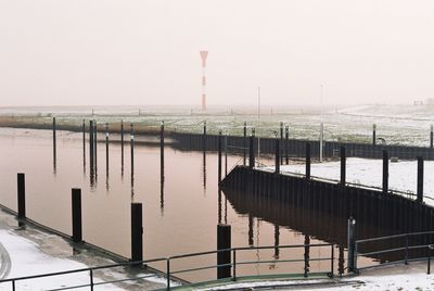 Scenic view of lake against clear sky during winter