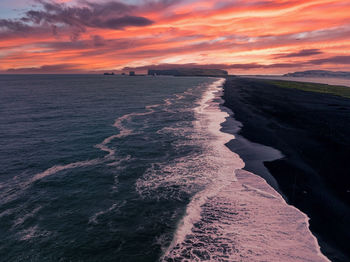 Iceland black sand beach with huge waves at reynisfjara vik.