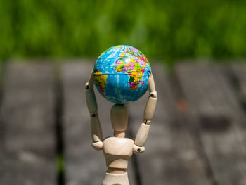 Close-up of figurine with globe