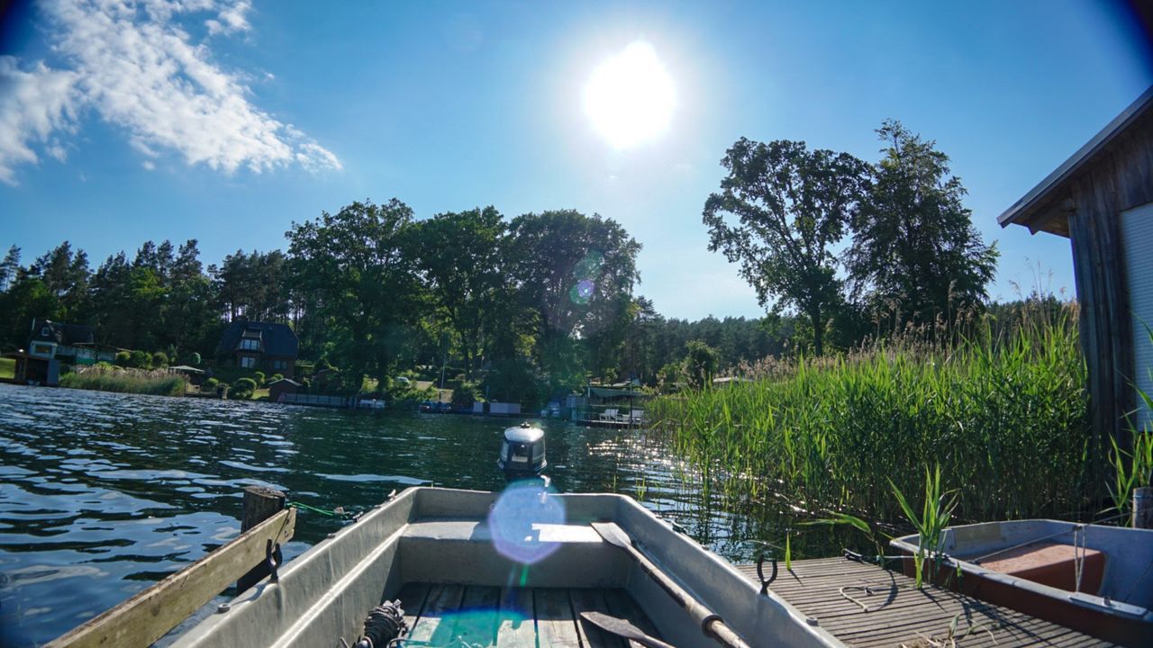 VIEW OF SWIMMING POOL BY LAKE AGAINST SKY