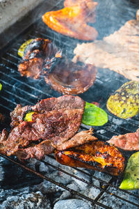 High angle view of meat on barbecue grill