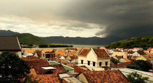 High angle view of houses against cloudy sky