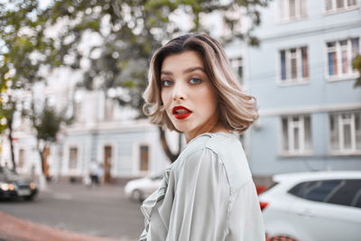 Portrait of beautiful woman standing in city