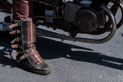 Low section of shoes on road in city