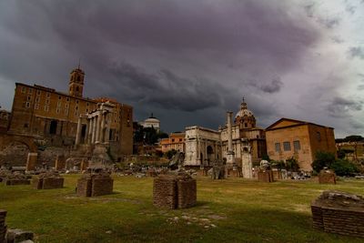 Roman ruins against cloudy sky