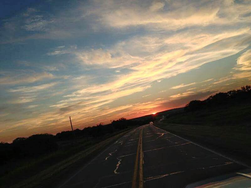 ROAD AMIDST LANDSCAPE AGAINST SKY DURING SUNSET