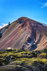 Scenic view of mountain against blue sky