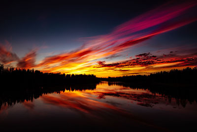 Scenic view of lake against romantic sky at sunset