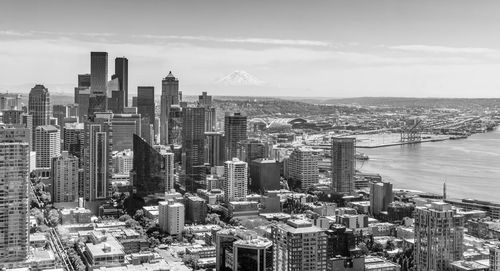 Buildings in downtown seattle with mount rainier in the distance.