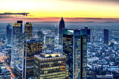 Modern buildings in city during sunset