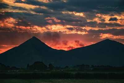 Scenic view of mountains against sky at sunset