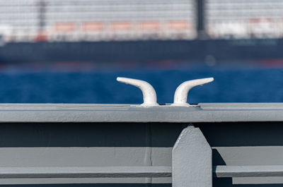 Close-up of metallic railing against sea