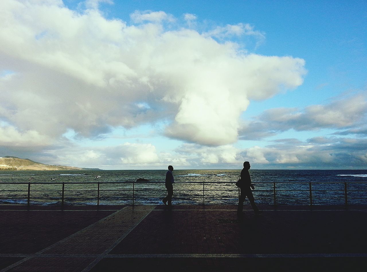 sky, railing, cloud - sky, water, sea, silhouette, cloudy, cloud, nature, scenics, fence, beauty in nature, tranquility, horizon over water, men, leisure activity, weather, lifestyles