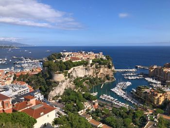 High angle view of townscape by sea against sky