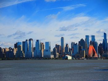 City skyline against cloudy sky