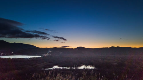 Scenic view of silhouette mountains against sky during sunset