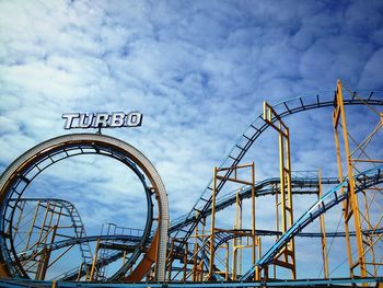 Low angle view of rollercoaster against sky